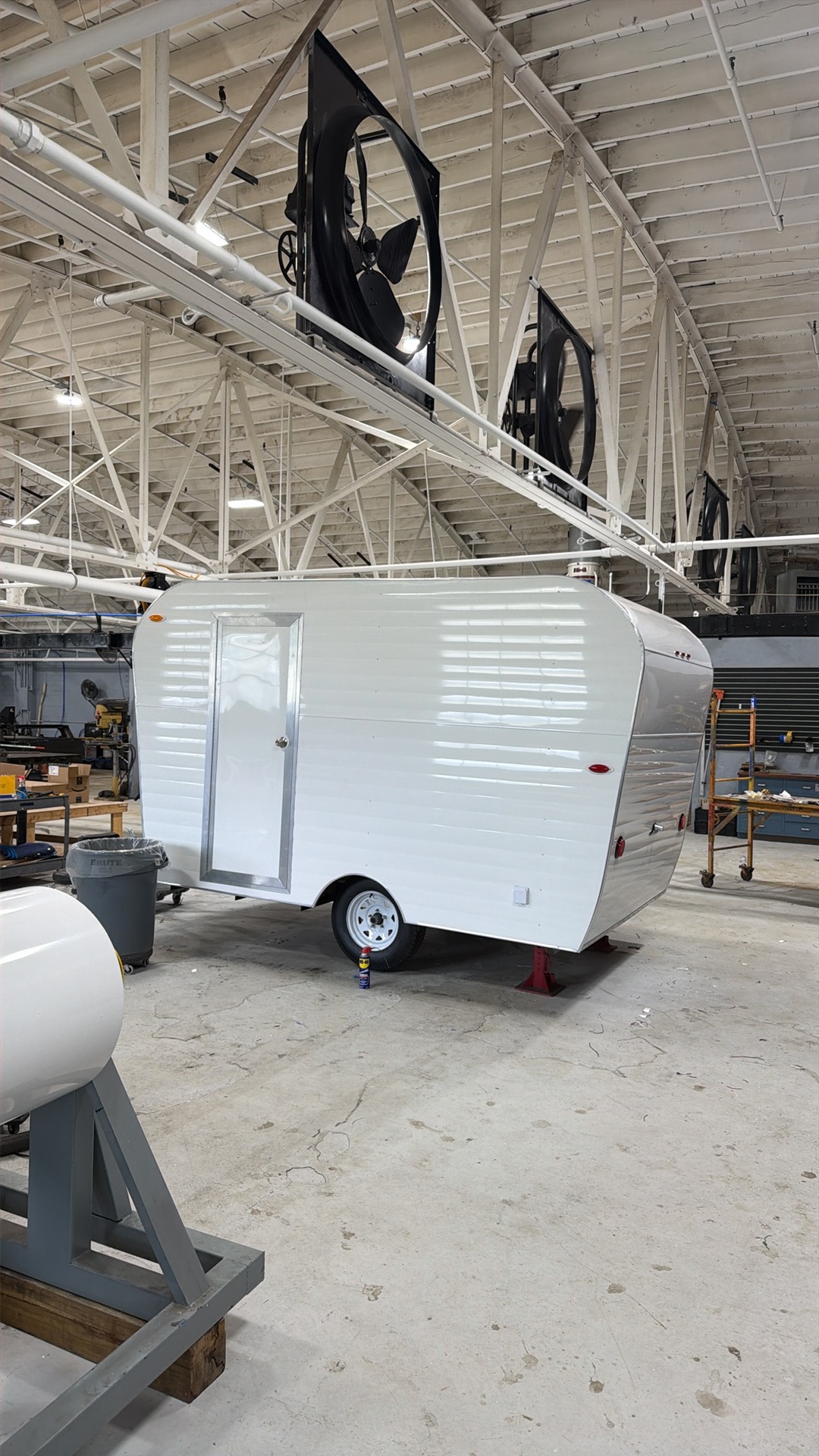White trailer shell in the shop with a side entry door