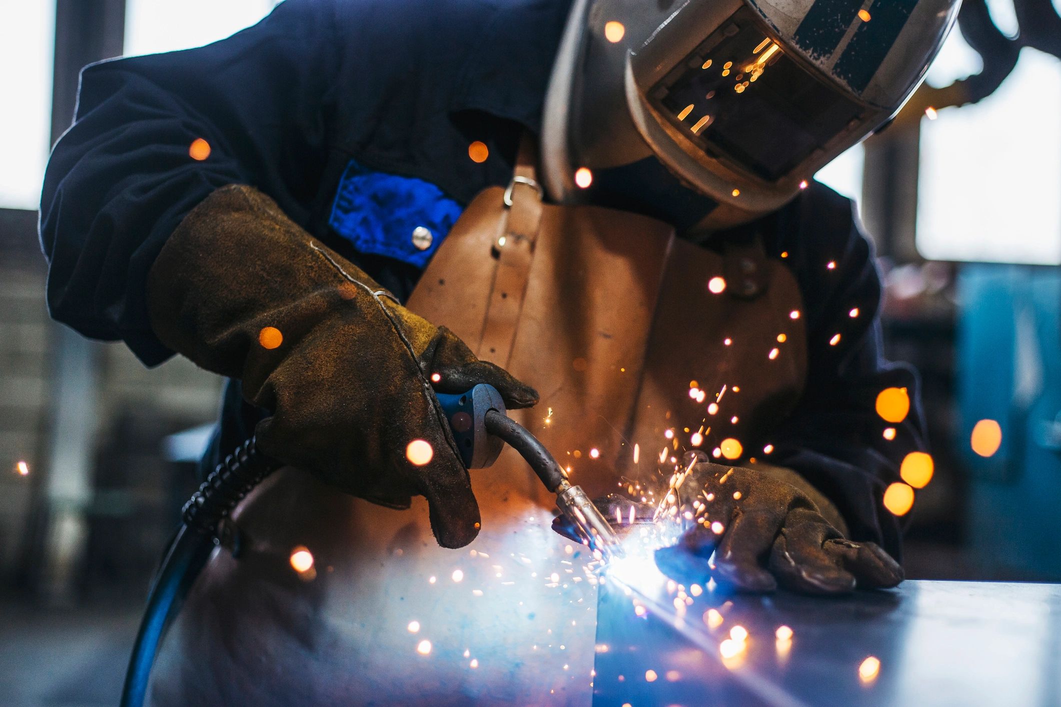 Welding sparks flying in a fabrication workshop
